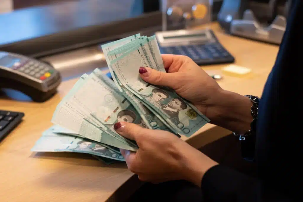 A Bank Teller Counting Dominican Pesos